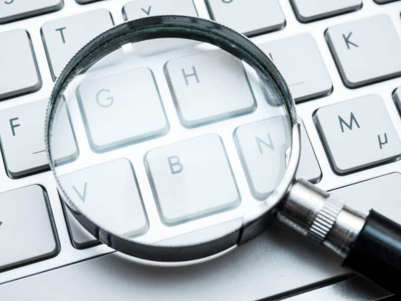 magnifying glasses on a laptop keyboard