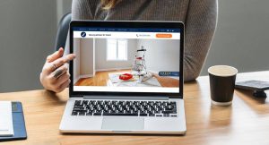 Woman pointing at a UENI example page on a laptop