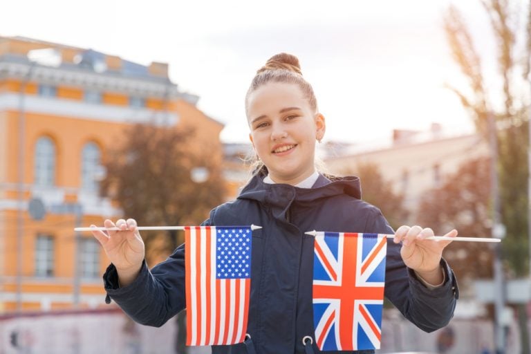 girl holding uk and usa flags