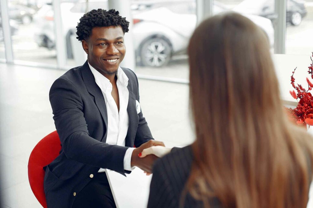 A customer shaking hands with a business woman in an office