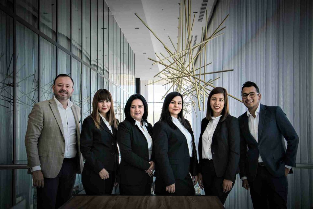 A team of business people posing for a team photo in the office

Photo by Marily Torres from Pexels