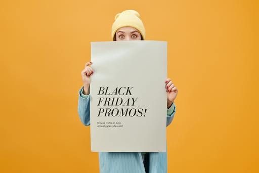 Woman holding a black friday poster with CTAs on it