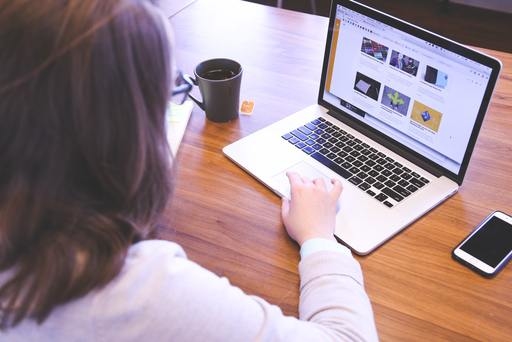 A woman looking at a website with a simple home page