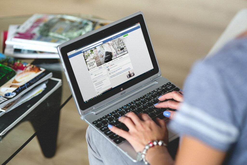 A Person Browsing Facebook on a Laptop 