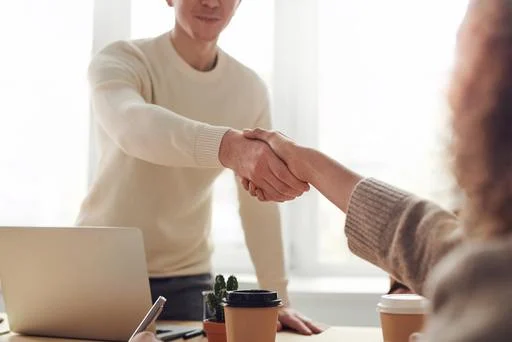 Two people shaking hands after a successful business meeting