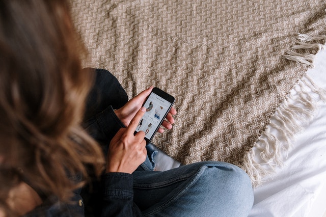 Woman browsing a shop on her smartphone