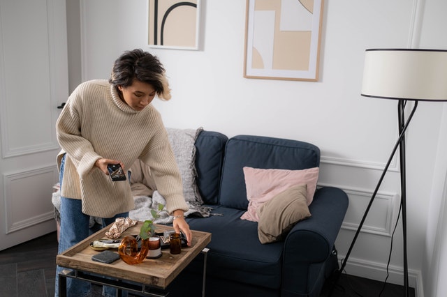 A woman setting up a craft photoshoot for her business.