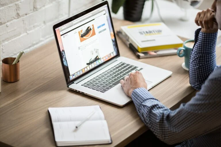 A man researching website providers on a laptop