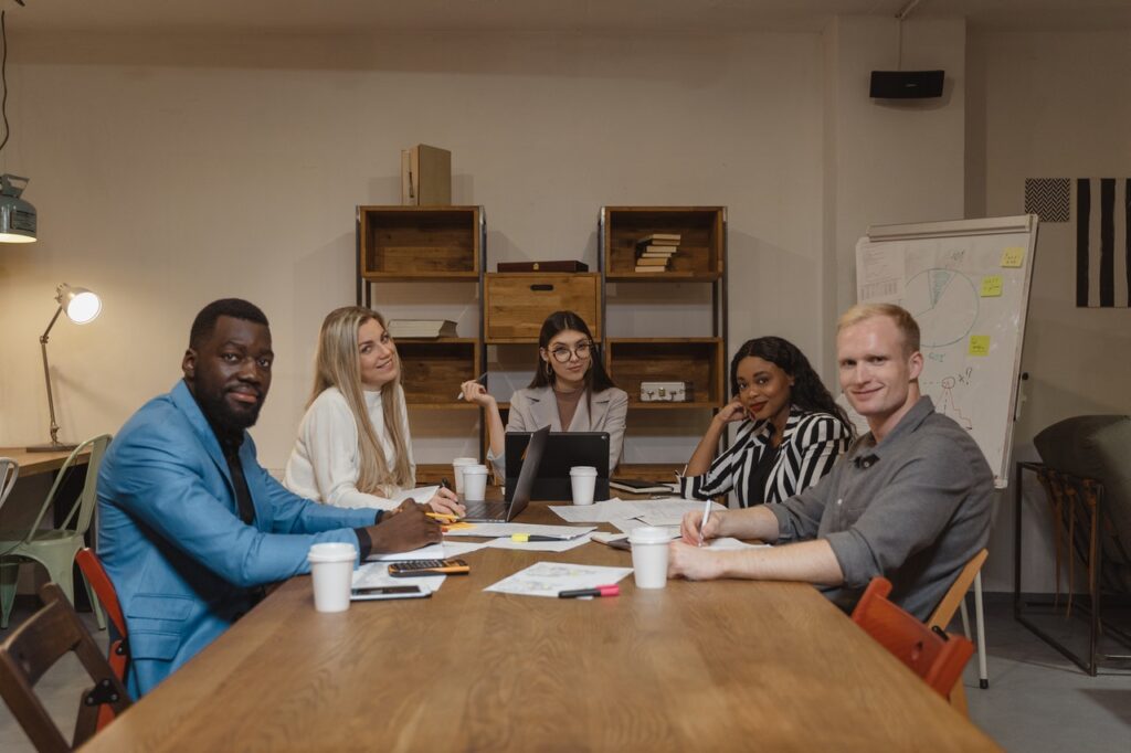 A team of entrepreneurs sitting at a table evaluating small business grants and loans