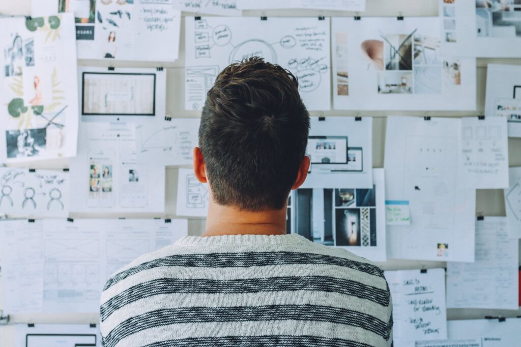 Man looking at a wall plan for marketing his small business