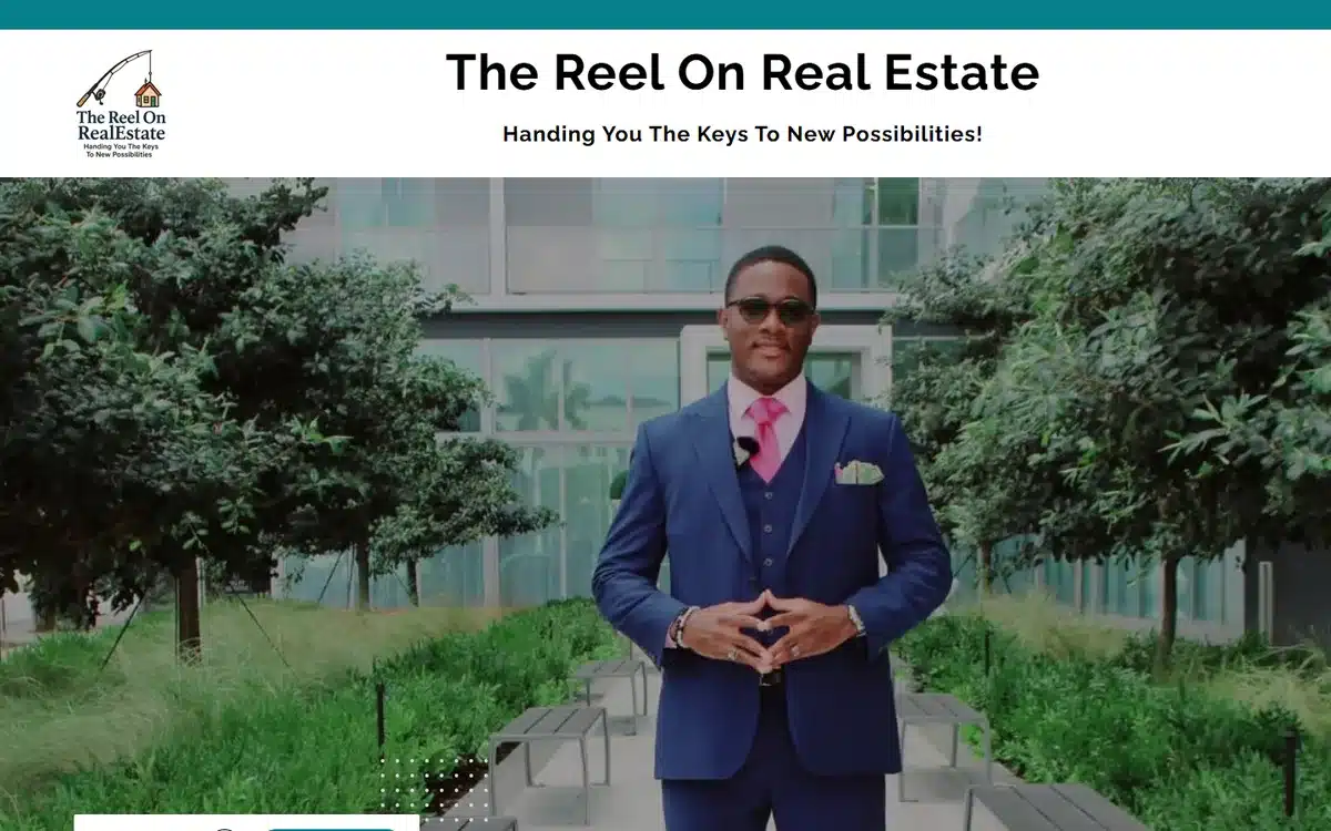 The Reel On Real Estate website with confident realtor portrait and Handing You The Keys tagline