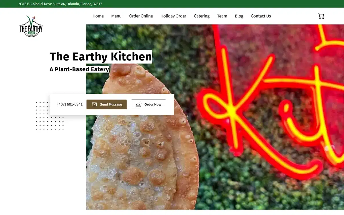 The Earthy Kitchen vegan restaurant website with neon signage and bold visual identity